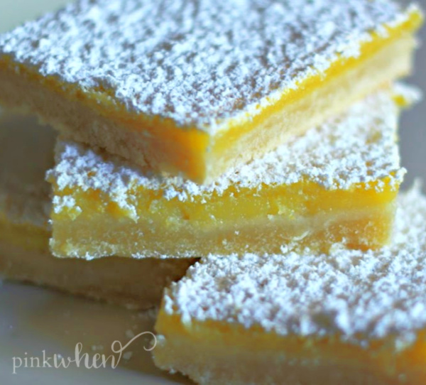 Lemon Bars stacked and topped with powdered sugar.