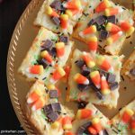 Candy corn cheesecake bars on a plate ready to serve.