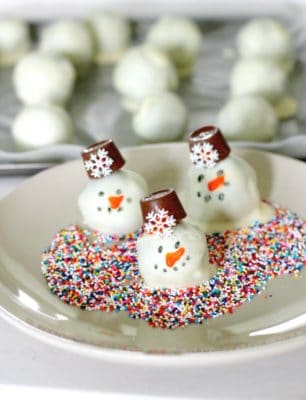 OREO Snowman Cookie balls on a white plate.