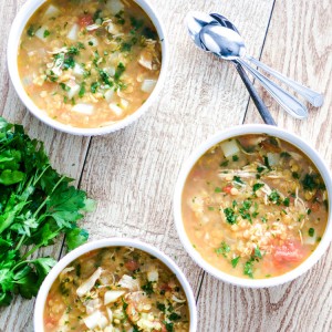 red lentil soup on wood table with spoon