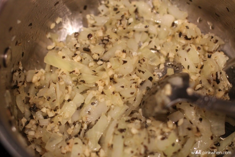 simmering onion, garlic, and seasonings in a saucepan.