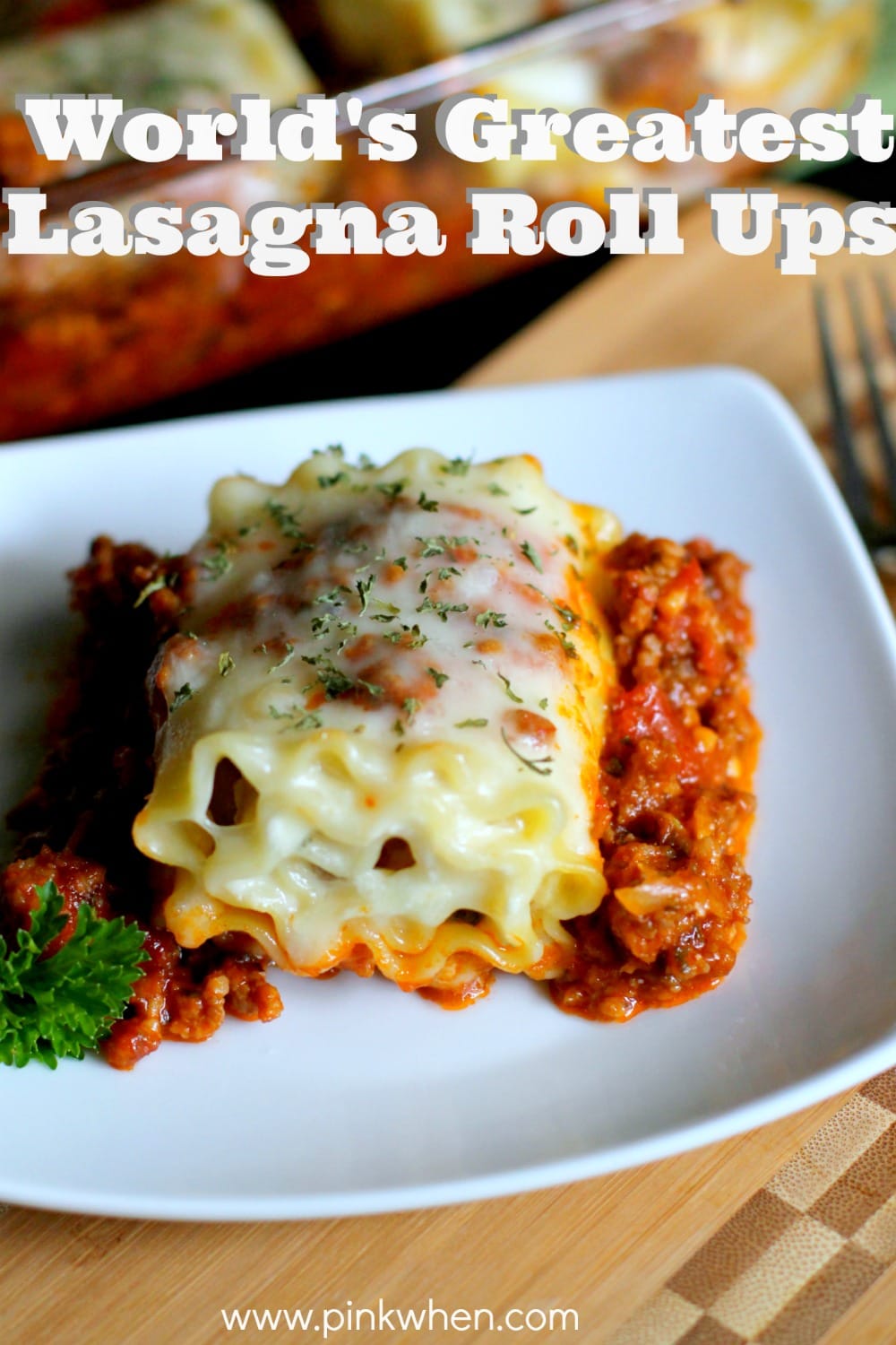 Lasagna roll ups on a pan in the background and on a white plate.