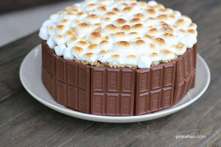S'mores Cake on a white plate and wooden table. 