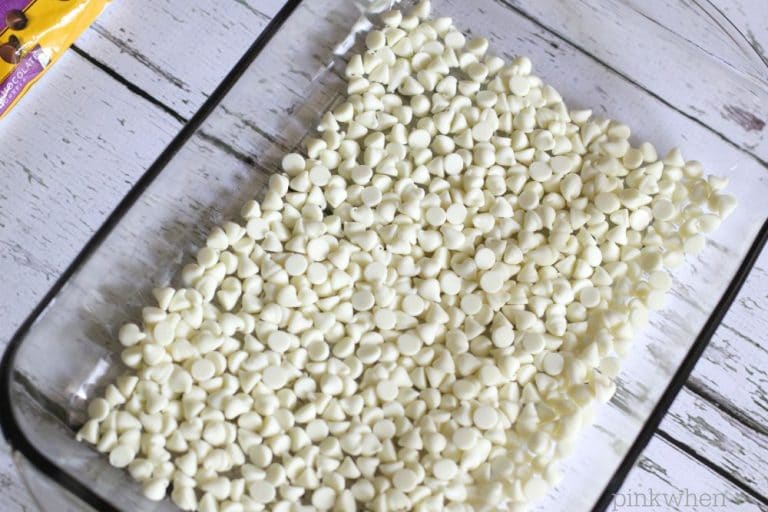white chocolate chips covering the bottom of a 9x13 baking dish