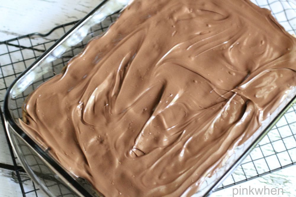 cookie dough bars covered in chocolate in a glass baking dish