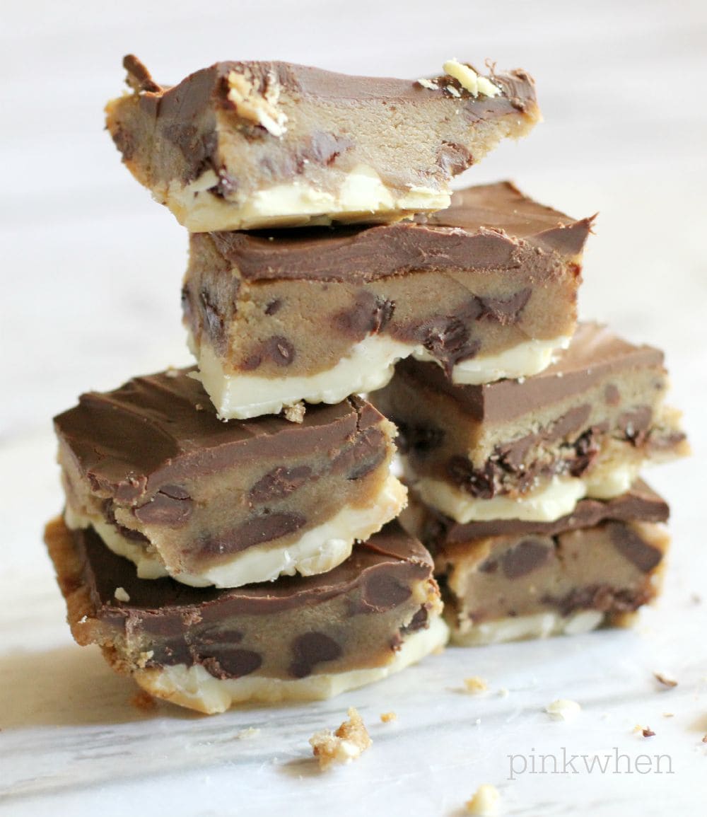 Ultimate Chocolate Chip Cookie Dough Bars stacked on white table