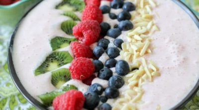 A Berry-licious smoothie bowl recipe made with strawberries, almonds, greek yogurt, organic milk, kiwi, blueberries, and raspberries. All with the daily recommended protein for breakfast of 25-30 grams!