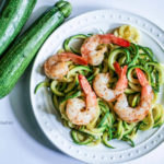 Shrimp scampi zoodles on a white plate