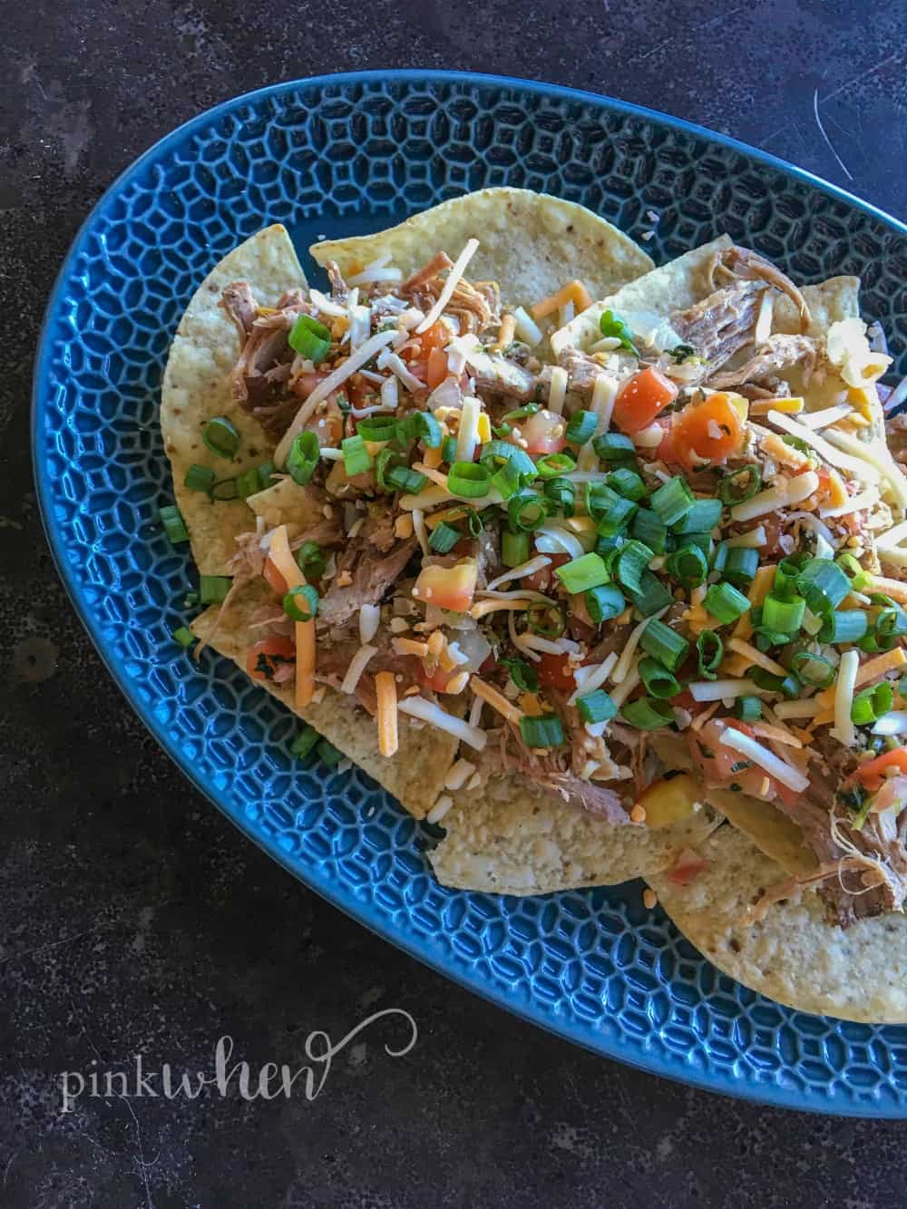 Delicious and easy Pulled Pork Nachos will be the hit of your next party. Check out just how easy these are to make! #pulledporknachos 