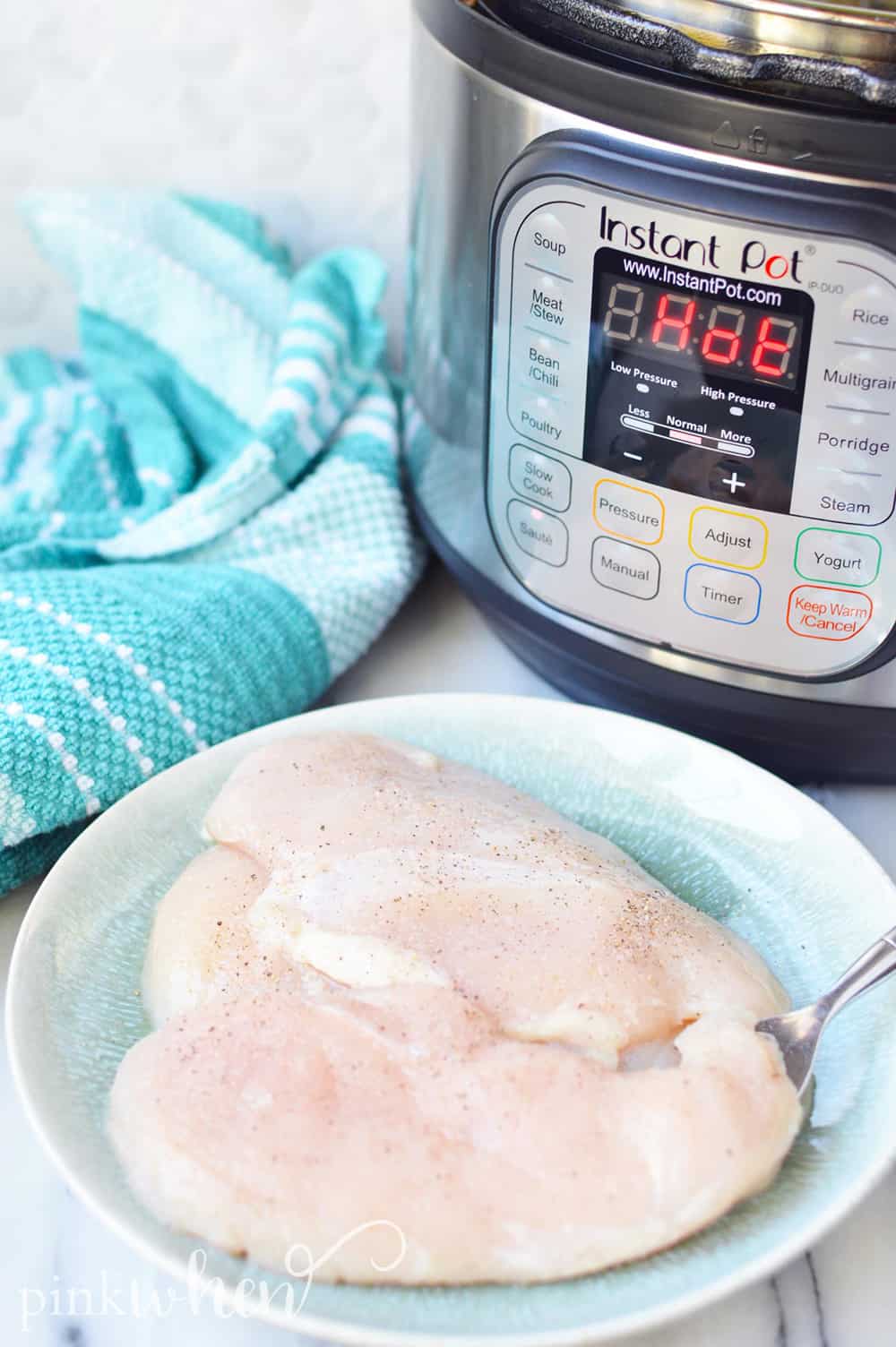 Instant Pot and seasoned raw chicken ready to cook.
