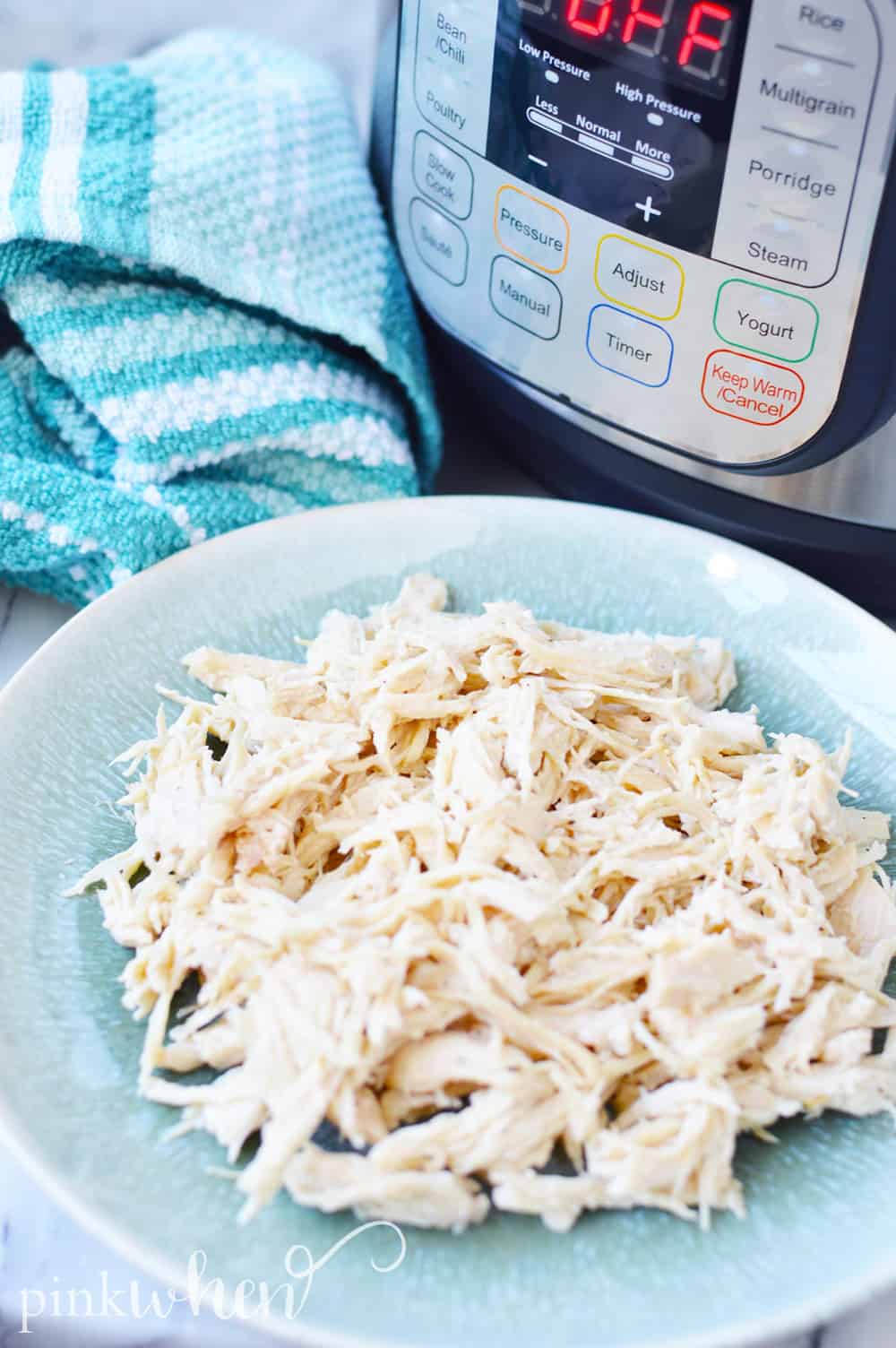 Instant Pot and shredded chicken on a plate