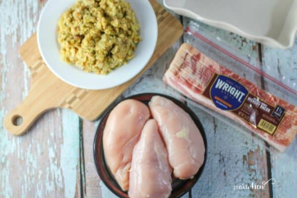 raw chicken on a plate, Wright® Brand Bacon, and dressing on a white plate.
