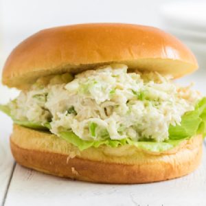 Chicken salad on a bun and ready to eat.