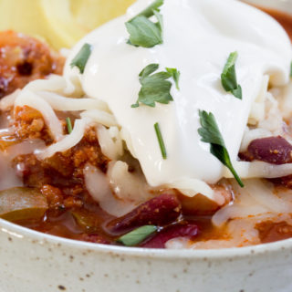 the best chili recipe topped with sour cream and green onion.