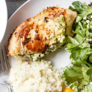 Feta Spinach Stuffed Chicken Breast on a plate with salad.
