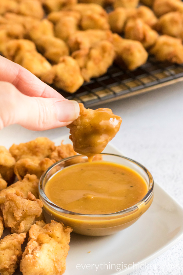 copycat chick fil a nuggets being dipped in a sauce.