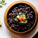 Instant Pot Black Beans in a bowl, garnished, and ready to serve.