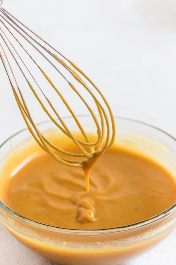 Homemade chick fil a sauce in a bowl with a whisk. 