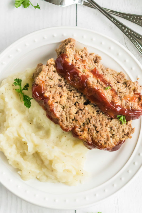 Sliced meatloaf with mashed potatoes and ready to serve.