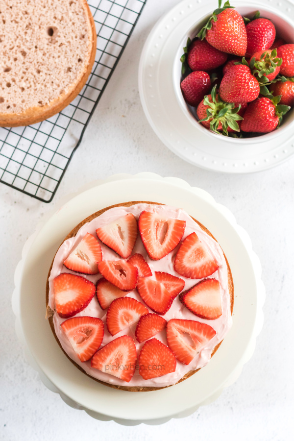 Strawberry Cake layer with cream cheese frosting and fresh strawberries.