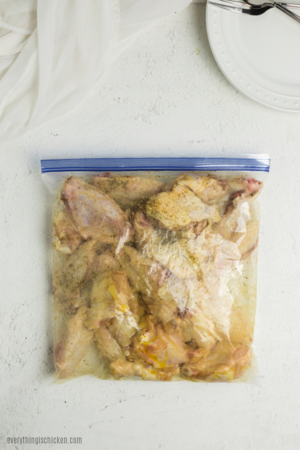 Wings getting coated in a ziplock bag