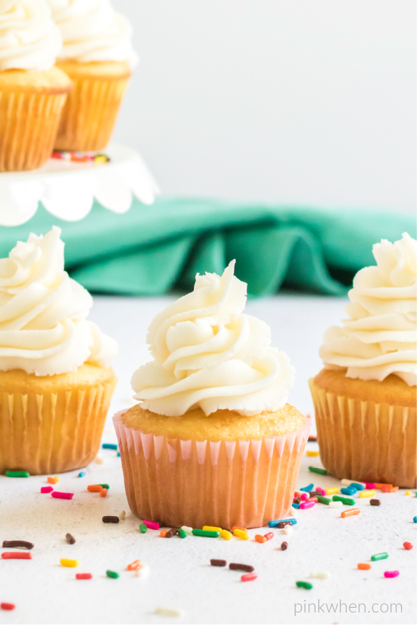 Buttercream frosting piped onto cupcakes. 