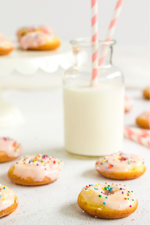 Donuts with a glass of milk in the background.