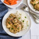 Instant Pot Chicken Thighs on a plate with rice.