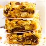 Chocolate Chip Cookie Bars stacked with parchment paper.