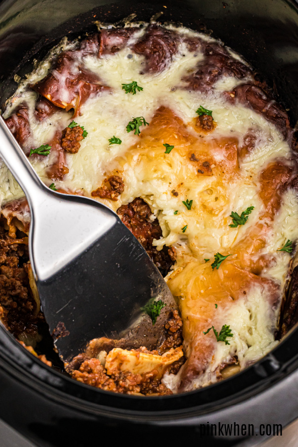 Lasagna inside of a crockpot ready to serve.