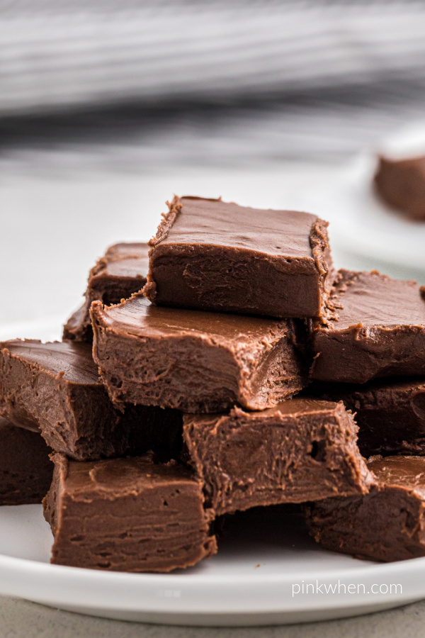 Easy fudge recipe - 2 ingredient fudge stacked on a white plate. 
