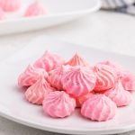 Pink Meringue Cookies on a white plate.