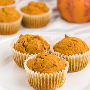 Pumpkin muffins on a white plate.