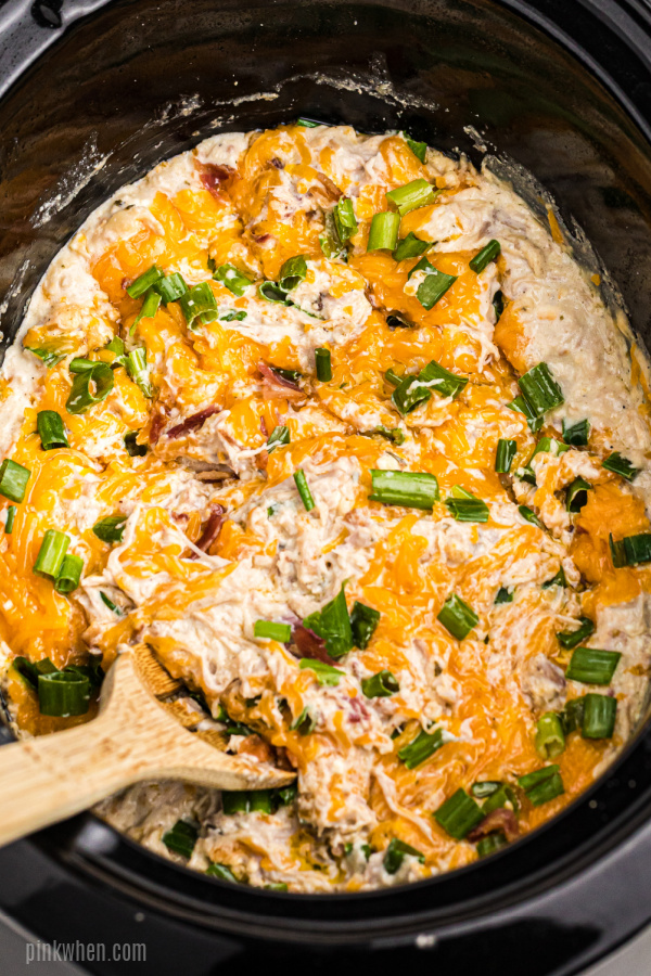 Crack chicken recipe in a crockpot with a serving spoon.