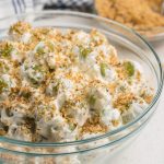Recipe for grape salad mixed and combined with pecan topping and ready to serve.