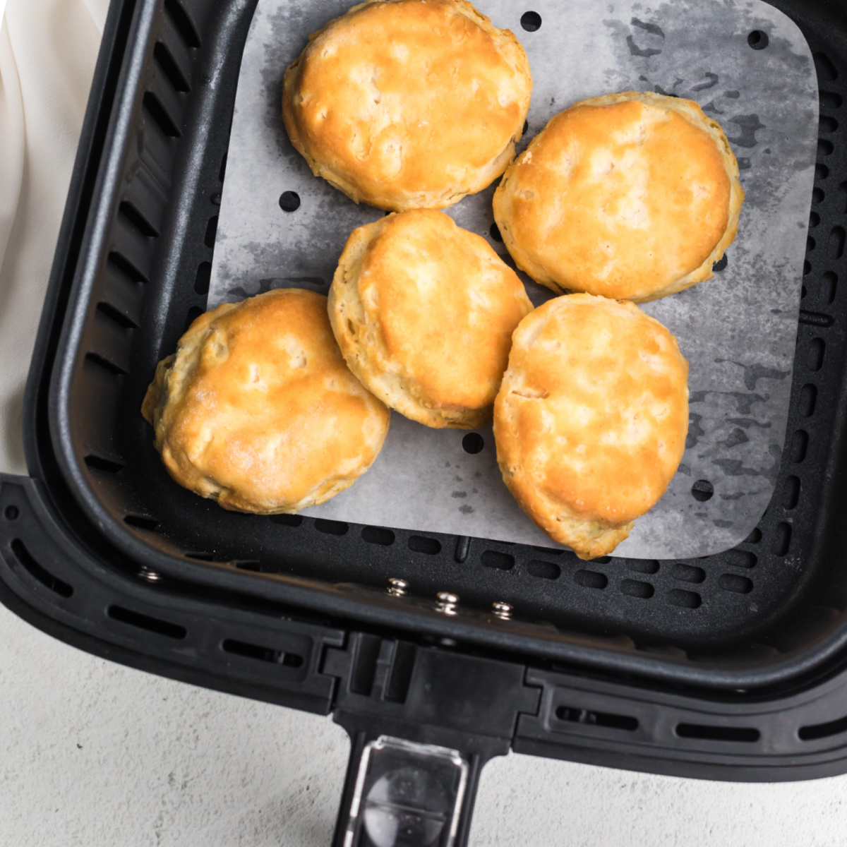 Biscuits in the Air Fryer basket after cooking.