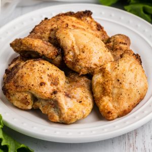 Chicken Thighs made in the Air Fryer and served on a white plate