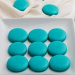 Blue Macaron cookies on a white plate.