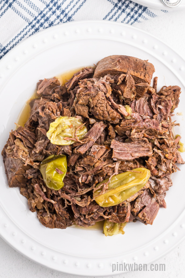 Pressure Cooker Mississippi Pot roast made in the Instant Pot on a white plate ready to serve.