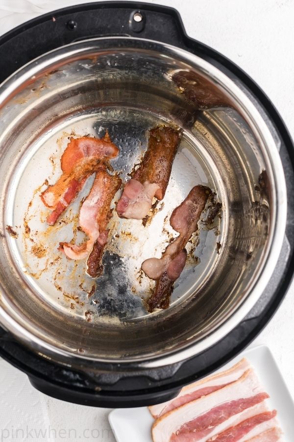 Bacon frying in the bottom of an Instant pot pressure cooker. 