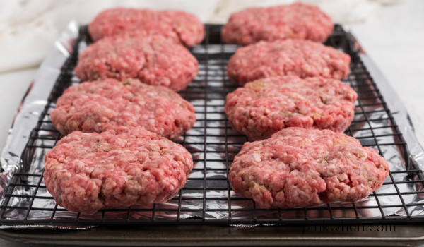 Hamburger meat shaped into patties for baking. 