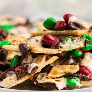 Christmas CRack Saltines piled high on a white plate.