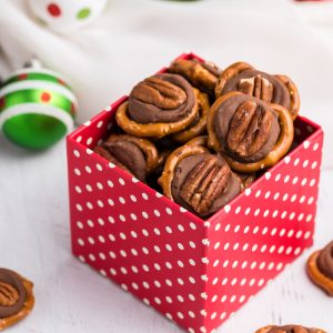 Pretzel Turtles made with Rolo candy in a red box.