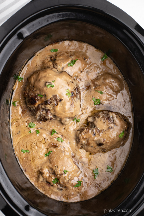 Fully cooked Salisbury Steak and gravy in the liner of a slow cooker. 