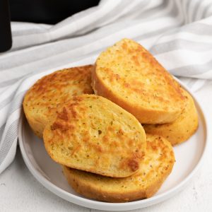 Cheese Toast made in the Air Fryer, on a white plate.