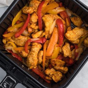 Air Fryer Fajitas with chicken and vegetables in the air fryer basket.