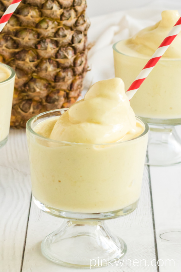 Dole Whip Recipe in a glass with a red and white straw and ready to serve.