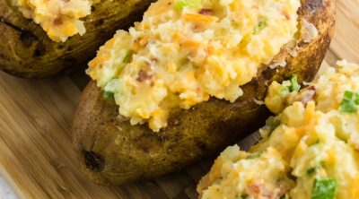 Twice Baked Potatoes on a cutting board ready to serve.