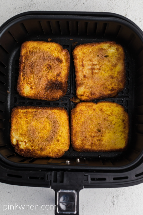 Cooked French Toast in the basket of the air fryer. 