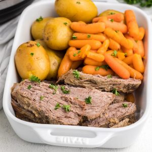 Instant Pot Tri Tip sliced and served with potatoes and carrots.